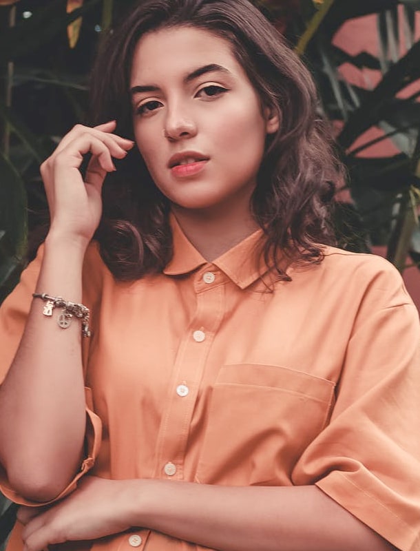 Brown haired woman wearing peach shirt