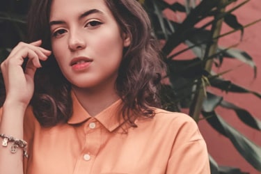 Brown haired woman wearing peach shirt